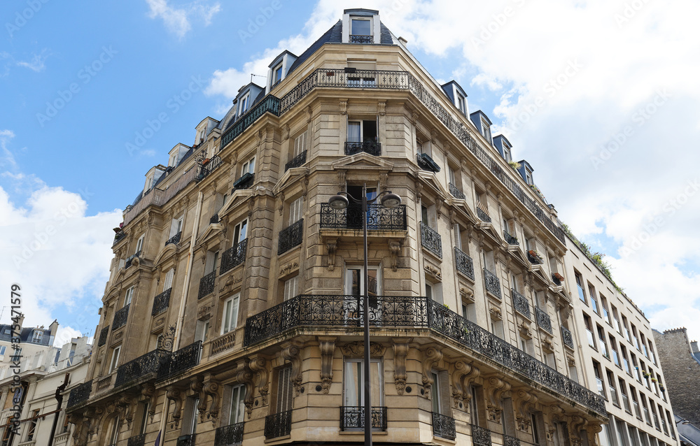 Obraz premium Traditional French house with typical balconies and windows. Paris.
