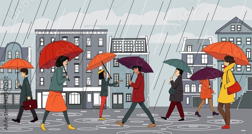 People in autumn clothes walk with umbrellas in the rain on the city street.