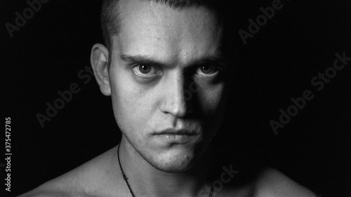 portrait of a young man on a black background