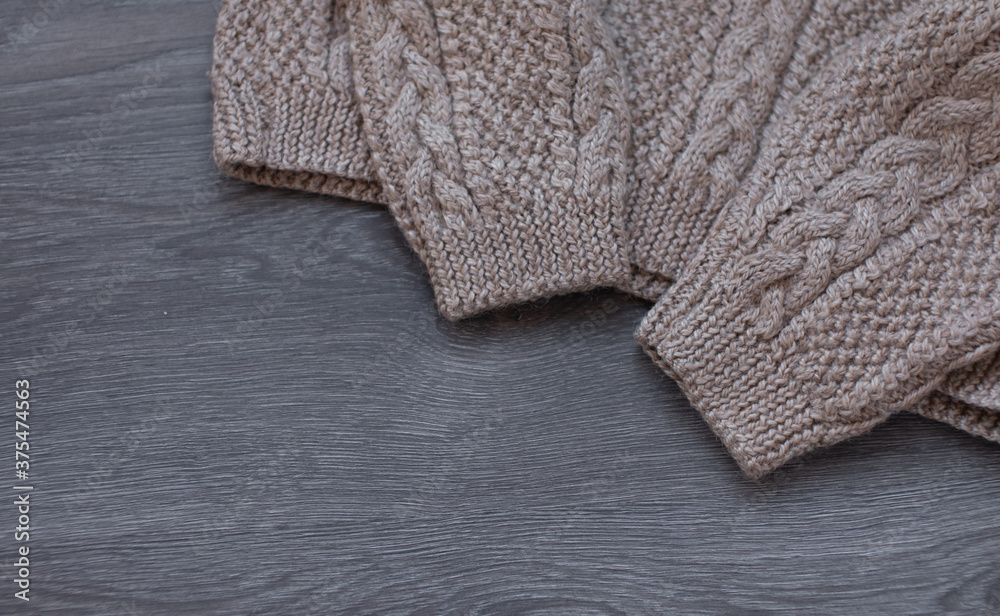 Knitted warm sweaters on wooden table. Knitted warm sweaters on wooden table.