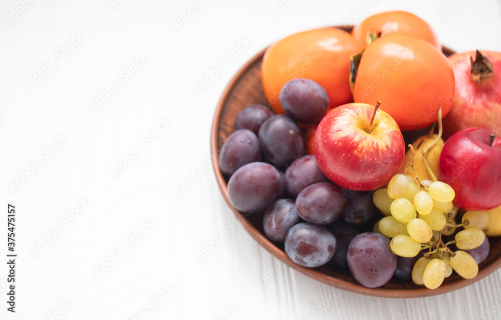 Autumn composition with fresh fruits. Apple, plum, melon, persimmon, pomegranate, grapes. Selective focus. Autumn composition with fresh fruits. Apple, plum, melon, persimmon, pomegranate, grapes. Selective focus.