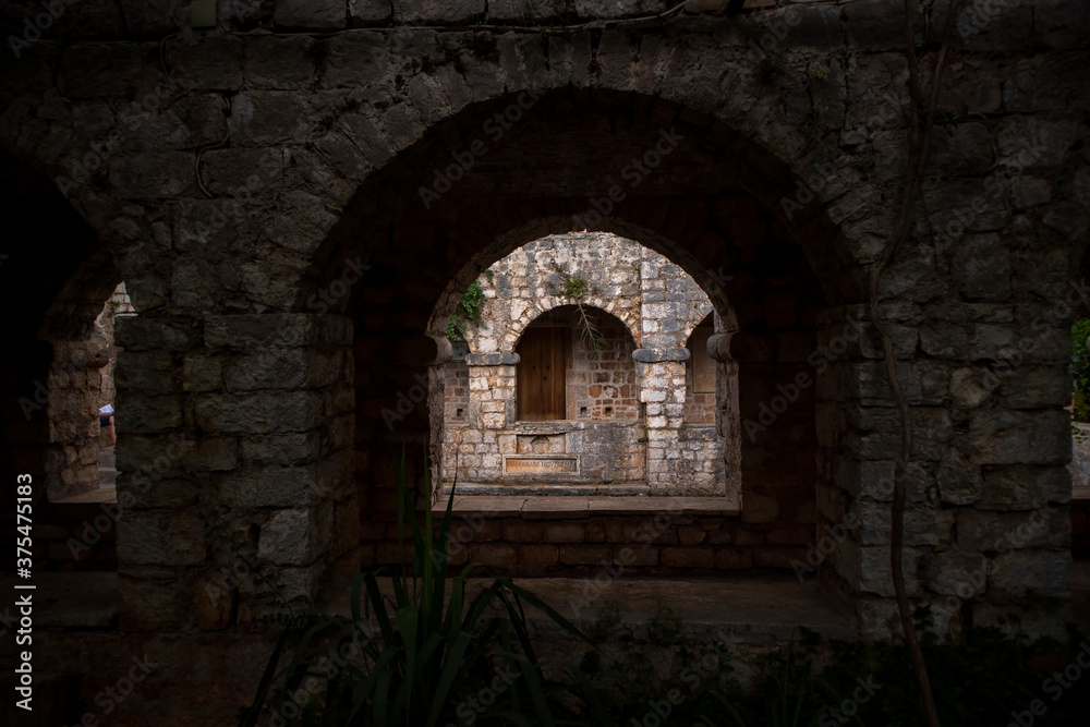 Stari Grad/Croatia-August 7th,2020: Old stone arches around salt water pool in the atrium of 