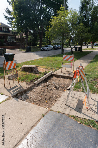 Vertical Suburban Neighborhood Sidewalk under Construction Barriers