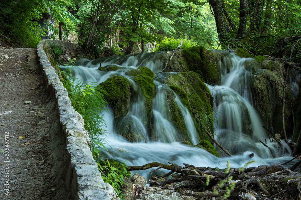 Waterfall with turquoise water in the Plitvice Lakes National Park, Croatia. Waterfall with turquoise water in the Plitvice Lakes National Park, Croatia.