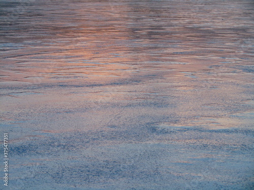 subtle blue orange sunset hue frozen ice with bubbles abstract
