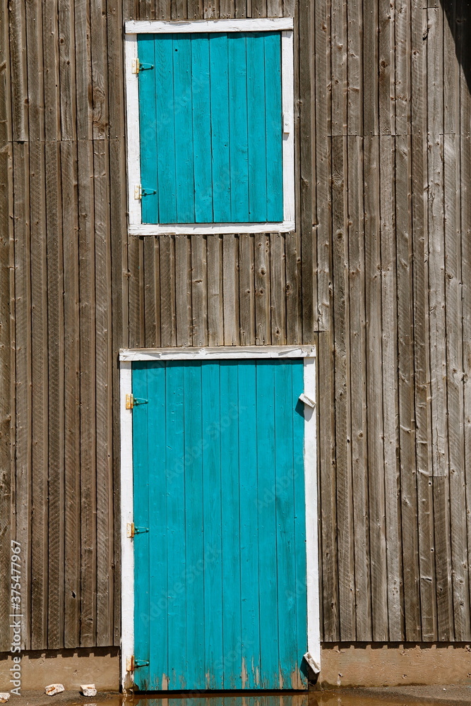 blue turquoise doors grey wood building blue turquoise doors grey wood building