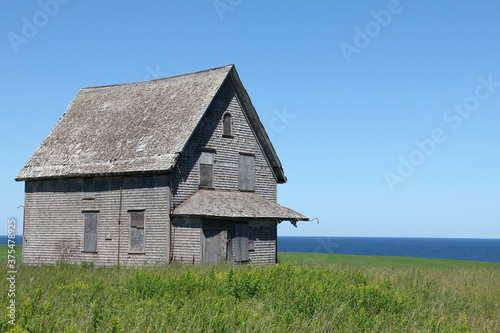 abandoned dream house with field and ocean