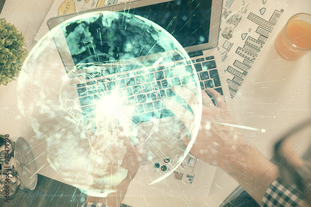 Double exposure of man's hands typing over computer keyboard and business theme hologram drawing. Top view. Financial markets concept. Double exposure of man's hands typing over computer keyboard and business theme hologram drawing. Top view. Financial markets concept.