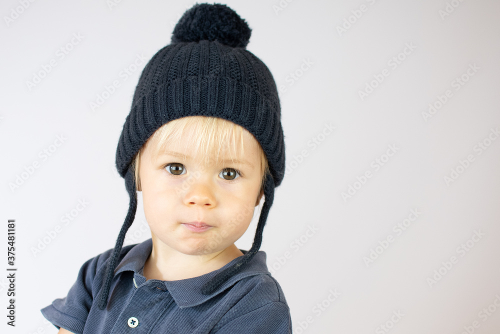 Smiling blond baby with a winter hat