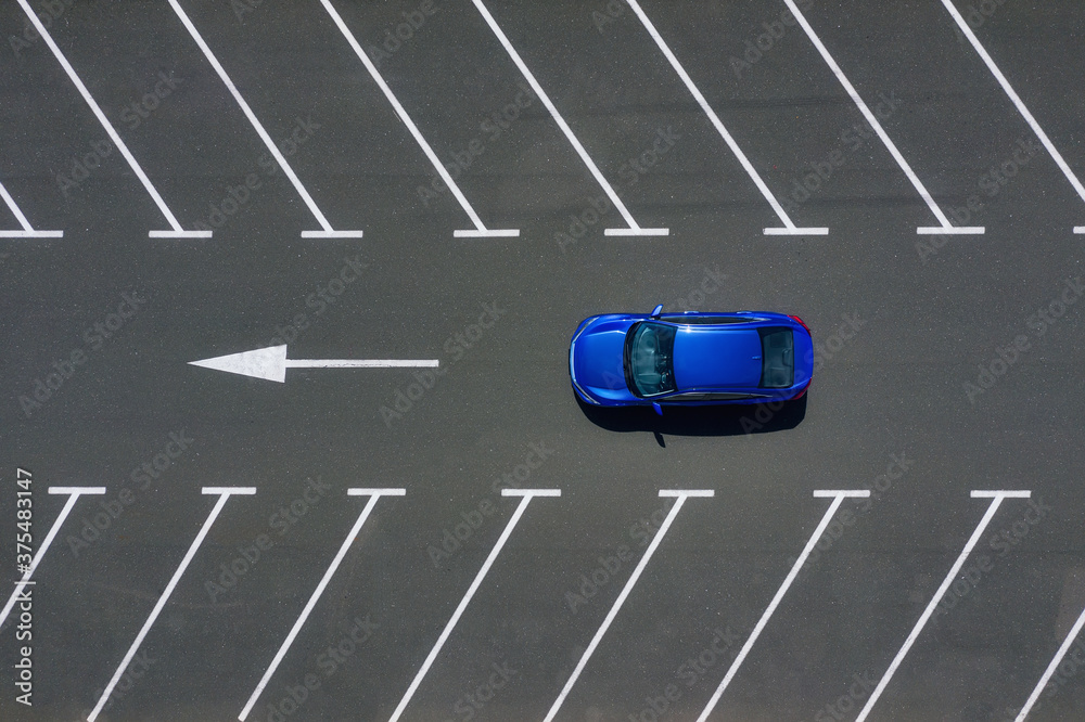 Transportation. View on the car from the air. Car in an empty parking lot. View of the vehicle from the drone. Travel by car.