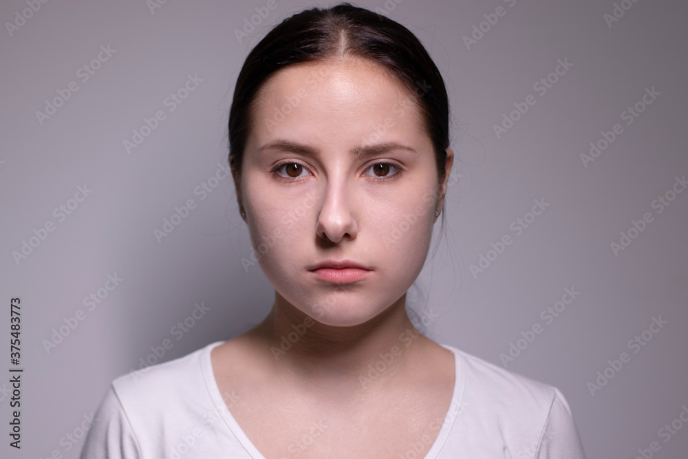 Fototapeta premium portrait of sad and depressed young woman. on gray background. nervous and upset people concept.