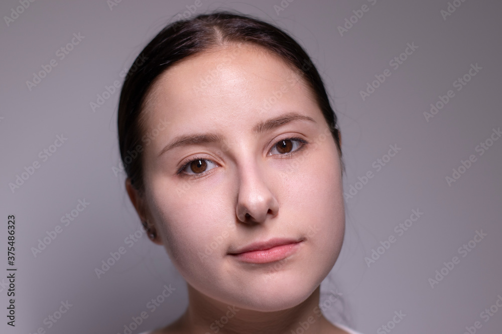 Close up portrait of pretty confident pensive thoughtful girl, looking seriously brunette. on grey background with copy space. People lifestyle concept Close up portrait of pretty confident pensive thoughtful girl, looking seriously brunette. on grey background with copy space. People lifestyle concept