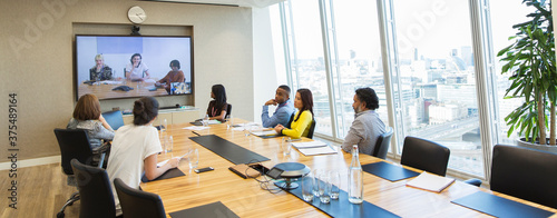 Business people video conferencing in conference room meeting photo