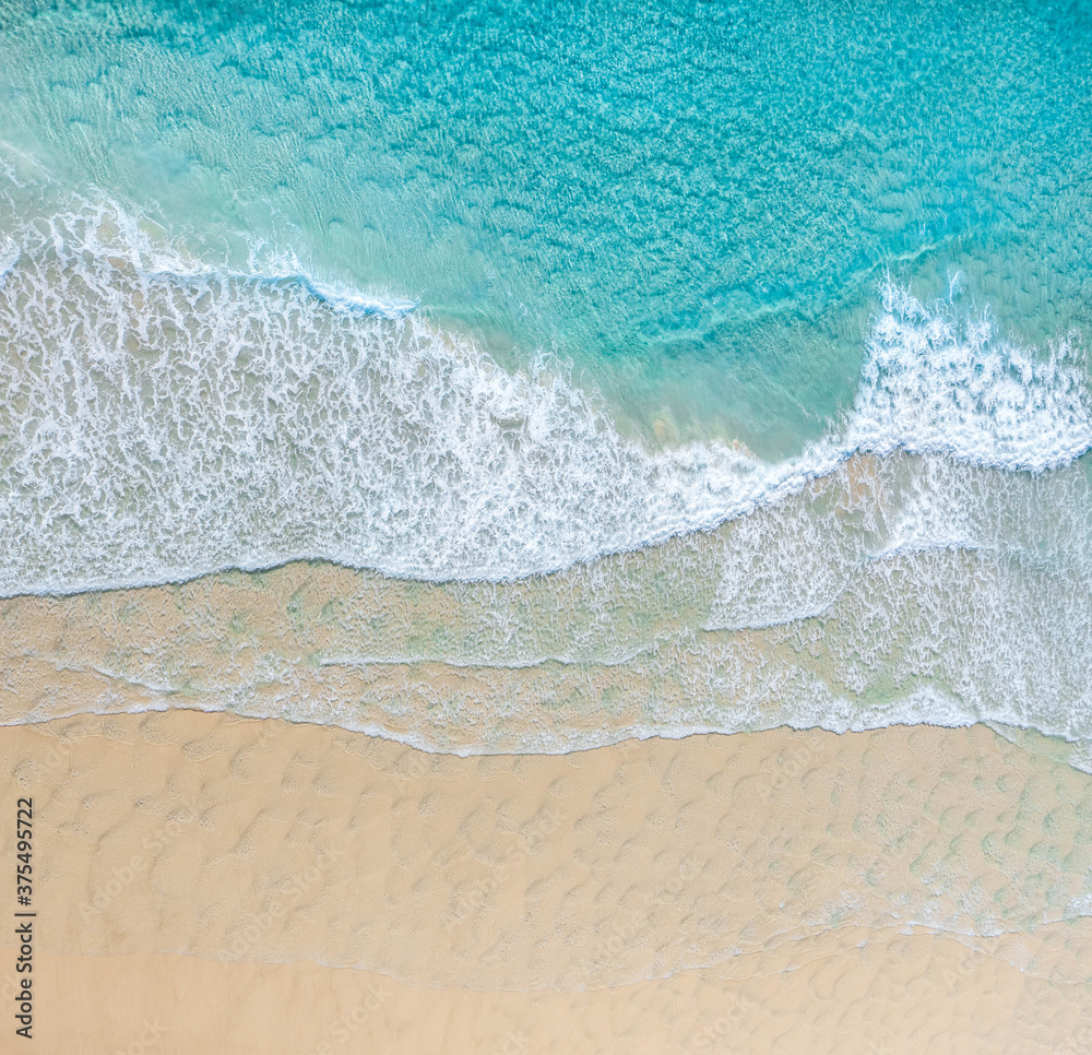 Aerial view of a beach with nice blue ocean, white sand and idyllic beach. - obrazy, fototapety, plakaty 