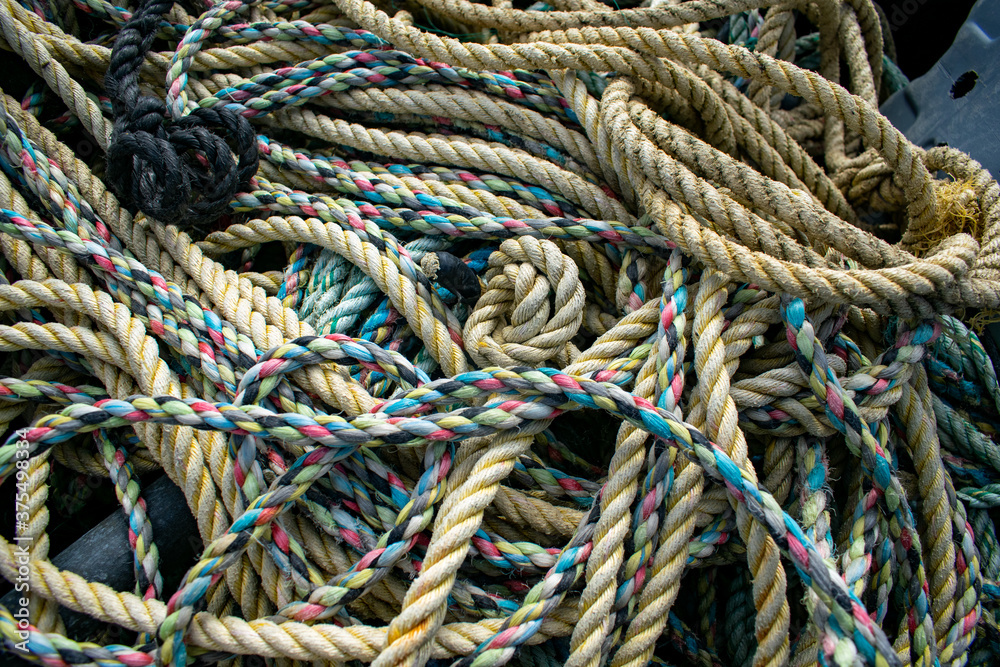 Tangled colorfull fishing ropes, rope variety used for sailing, marine background