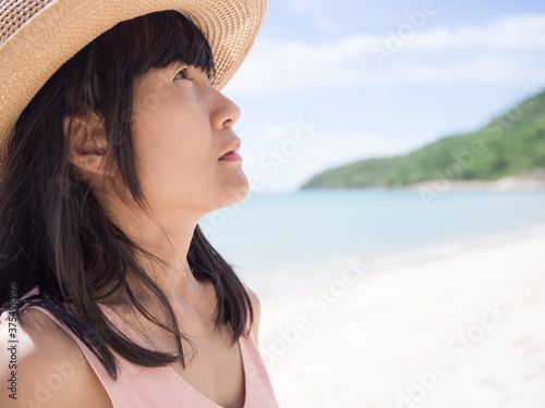 Portrait alone sadly woman on blur image of mountain and blue sea. she black hair and skin tan authentic thailand. summer travel holidays or broken heart concept.