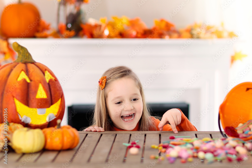 Fototapeta premium Kids in witch costume on Halloween trick or treat