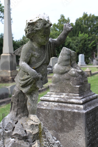 Stone angel child on grave in Hollywood Cemetery  Richmond  Virginia