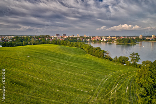 Town Of Elk in Poland with green field and lake in the foreground