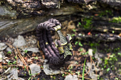 Braided paracord bracelet brown on the ground lock brass axe Perun © smolin