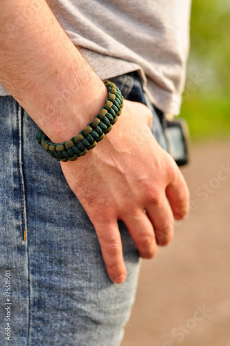 Braided Cobra paracord bracelet on a man's hand close up