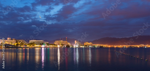 Night panoramic view on the central public beach of Eilat - famous tourist resort and recreational city in Israel