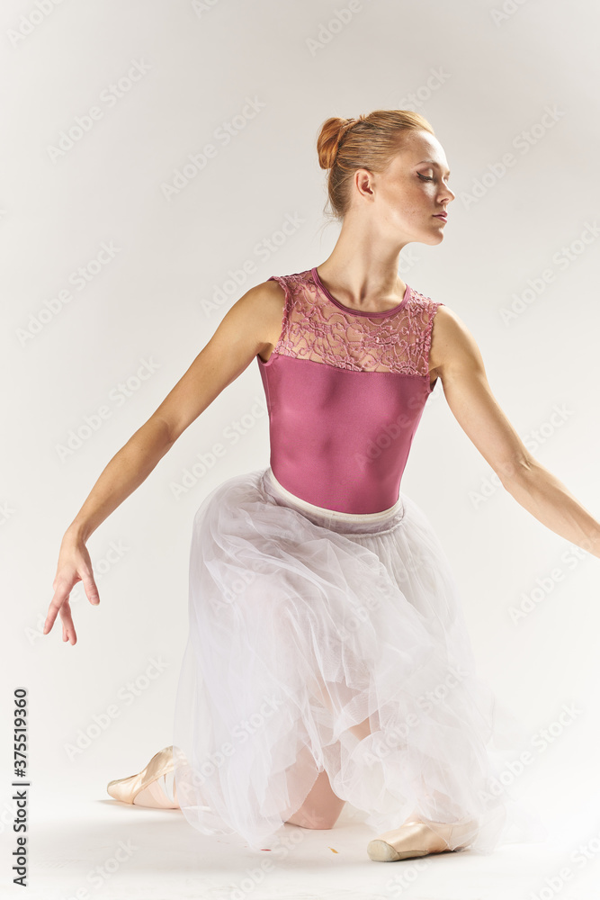 woman ballerina in pointe shoes and in a tutu on a light background poses posing legs dance model woman ballerina in pointe shoes and in a tutu on a light background poses posing legs dance model