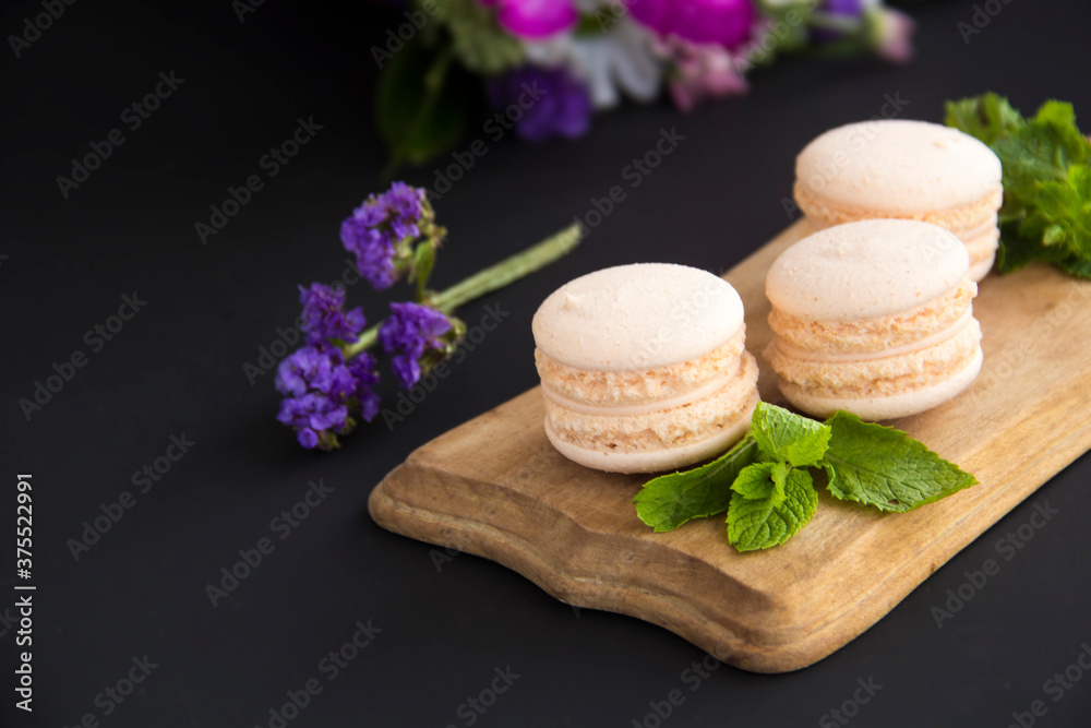 Macarons and mint for dessert - healthy organic summer dessert. Creative atmospheric decoration. Macarons and mint for dessert - healthy organic summer dessert. Creative atmospheric decoration.