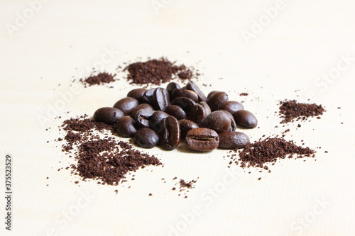 Coffee beans sugar and creamer on wood background