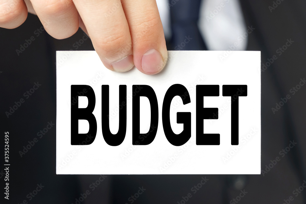 Businessman shows a card with the text - BUDGET Businessman shows a card with the text - BUDGET