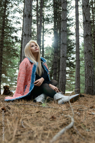 Beautiful asian woman relaxing in the middle of a pine forest.