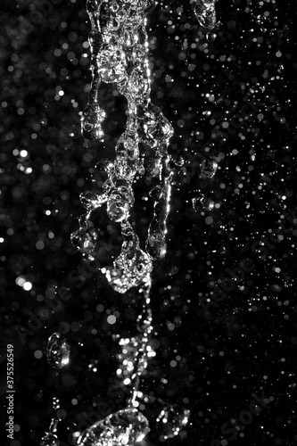 water jet with splashes and highlights on a black background