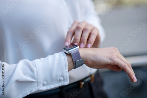 Close up picture of a woman touching a smartwatch