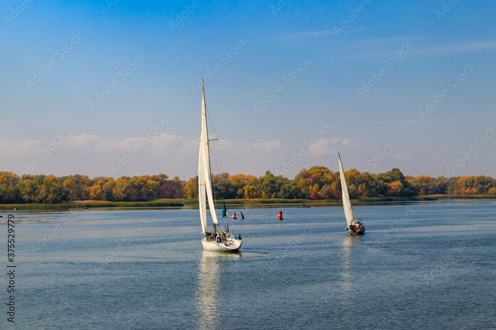 Yachts at sailing regatta on the Dnieper river in Kremenchug, Ukraine Yachts at sailing regatta on the Dnieper river in Kremenchug, Ukraine