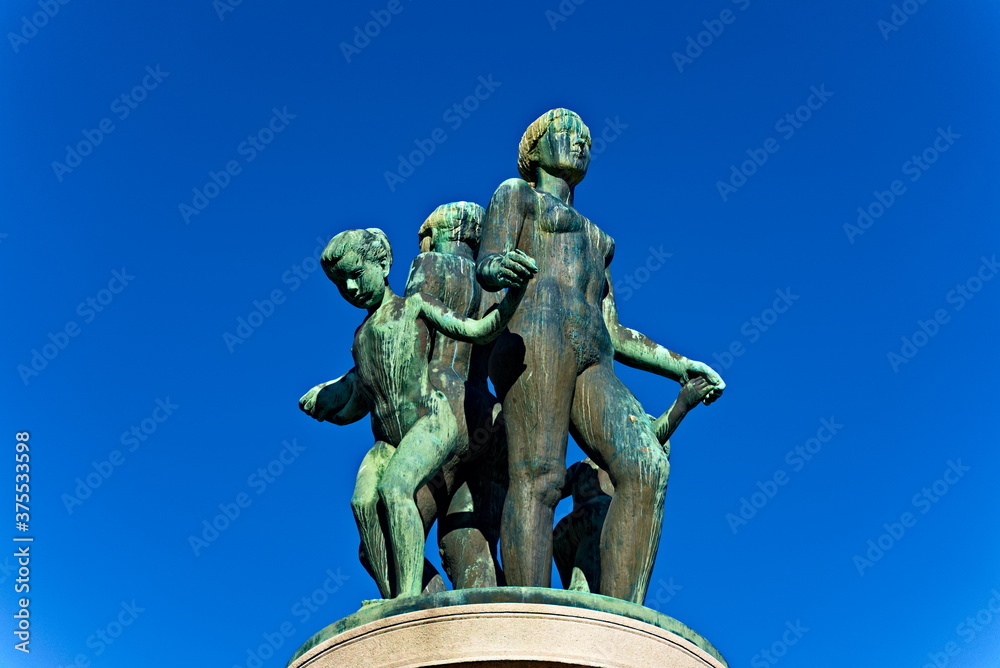 Bronze statue with green patina, resemblance of women and children dancing naked.