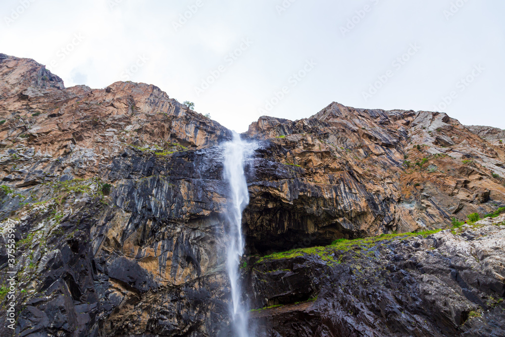 Obraz premium Mountain landscape with a river and a waterfall. Summer background. Belogorka gorge, Kyrgyzstan