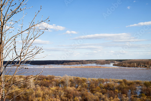 High water on a river or on a lake in sunny spring day