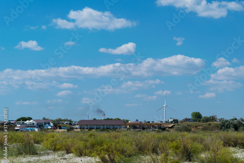Corbu, Constanta, Romania - August 18, 2019: Buildings powered with green electricity generated by windmils at Corbu Beach, Romania.