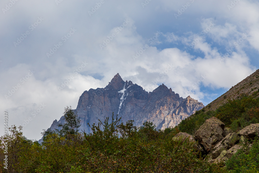 Mountain landscape with a river and a waterfall. Summer background. Belogorka gorge, Kyrgyzstan Mountain landscape with a river and a waterfall. Summer background. Belogorka gorge, Kyrgyzstan