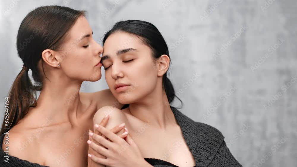 Sexy female lgbt couple hugging and kissing feeling love. Medium close up shot on 4k RED camera Sexy female lgbt couple hugging and kissing feeling love. Medium close up shot on 4k RED camera