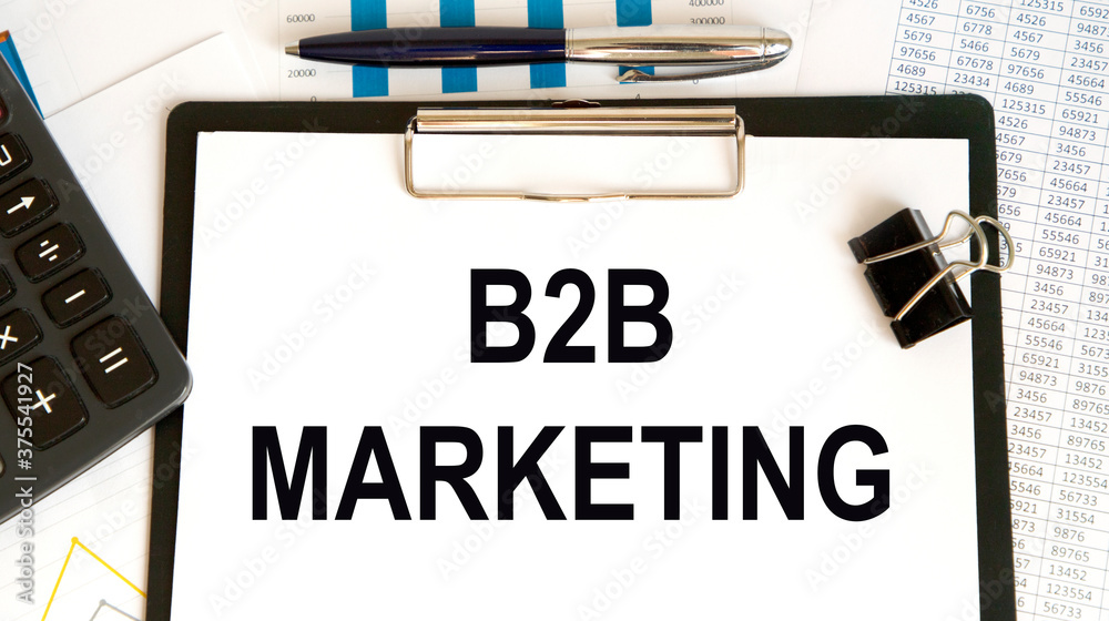 On a light background between the calculator and pen B2B marketing inscription On a light background between the calculator and pen B2B marketing inscription