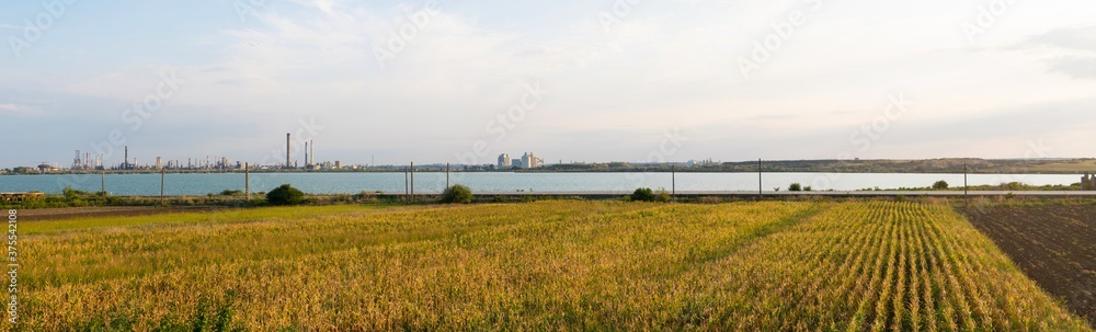 Constanta, Romania - August 16, 2019: Panoramic view of Lake Corbu with Navodari Petromidia Refinery in the background.