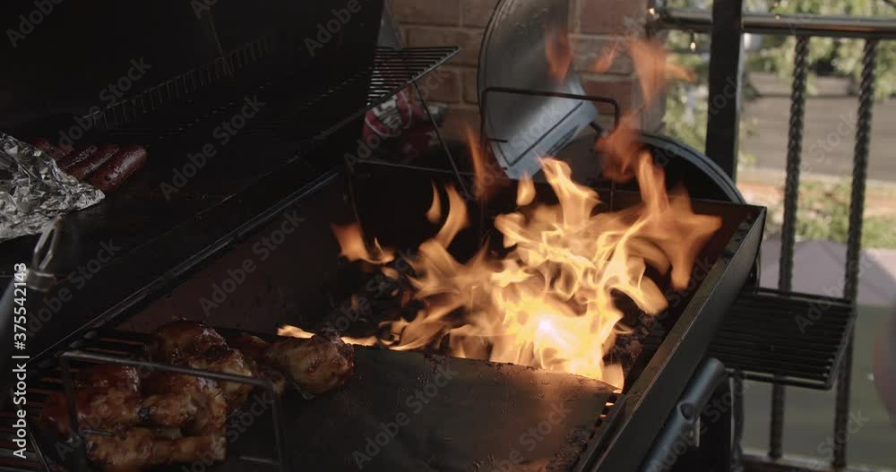 A normal speed 4k shot of flames coming from a pile of hot coals just before a summer holiday barbecue cookout. A normal speed 4k shot of flames coming from a pile of hot coals just before a summer holiday barbecue cookout.