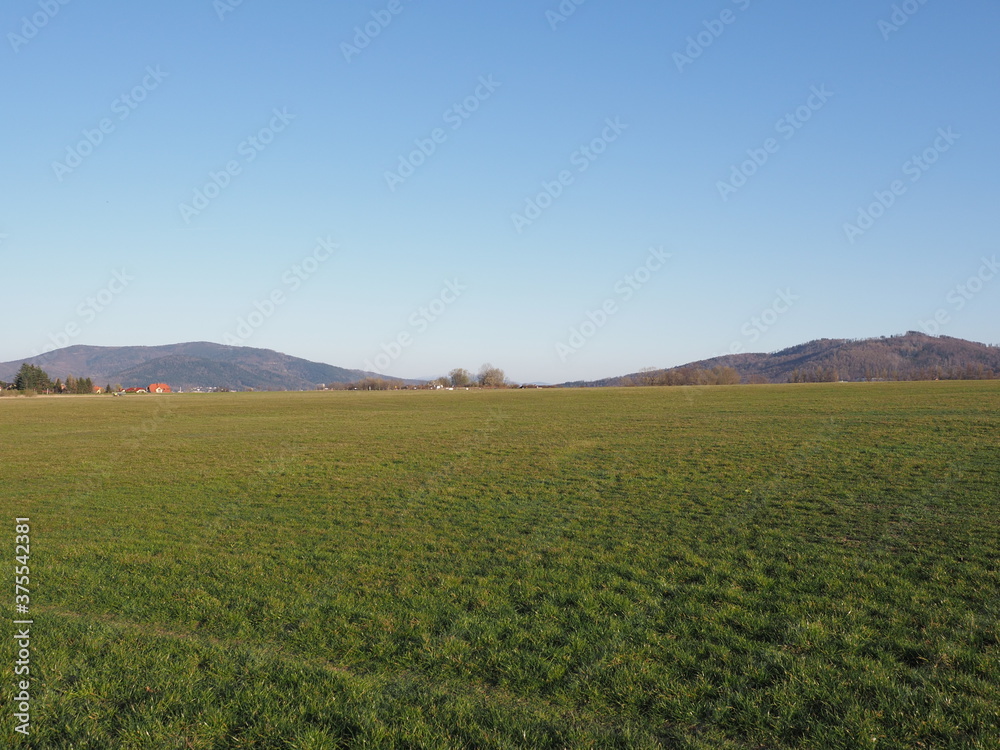 Fantastic Silesian Beskid Mountains range seen from sport airfield in european Bielsko-Biala city in Poland, clear blue sky in 2020 warm sunny spring day on April.