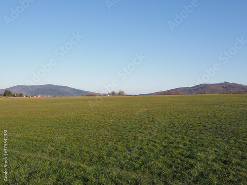 Fantastic Silesian Beskid Mountains range seen from sport airfield in european Bielsko-Biala city in Poland  clear blue sky in 2020 warm sunny spring day on April.