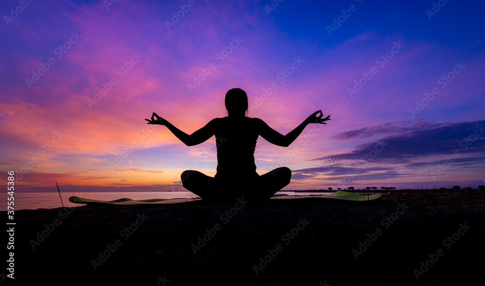 Silhouette woman make practice yoga and meditation for healthy with twilight sky background