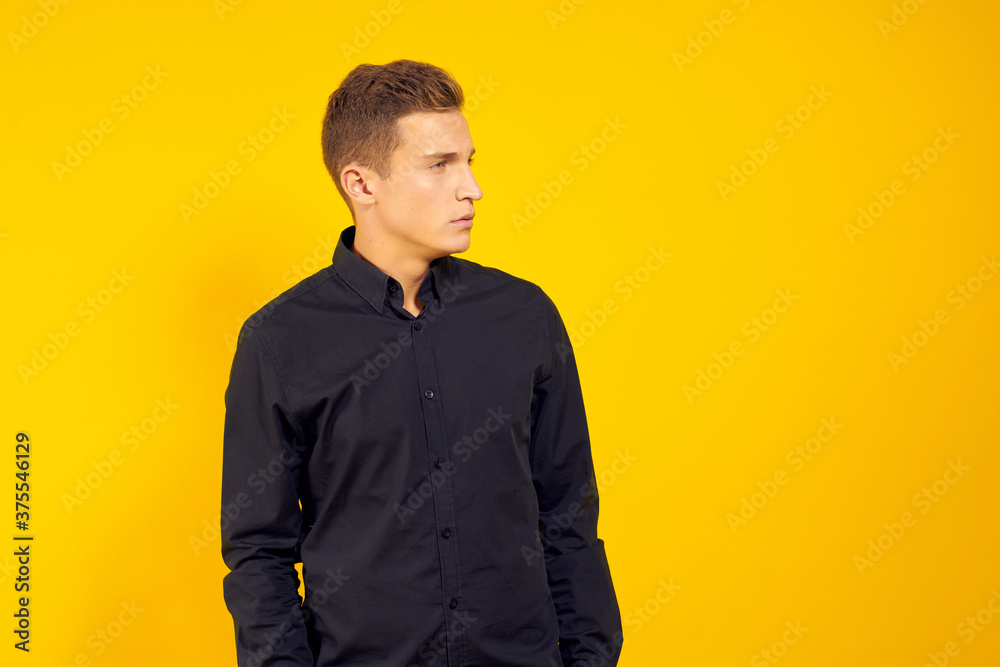 emotional man in black shirt lifestyle yellow isolated background emotional man in black shirt lifestyle yellow isolated background
