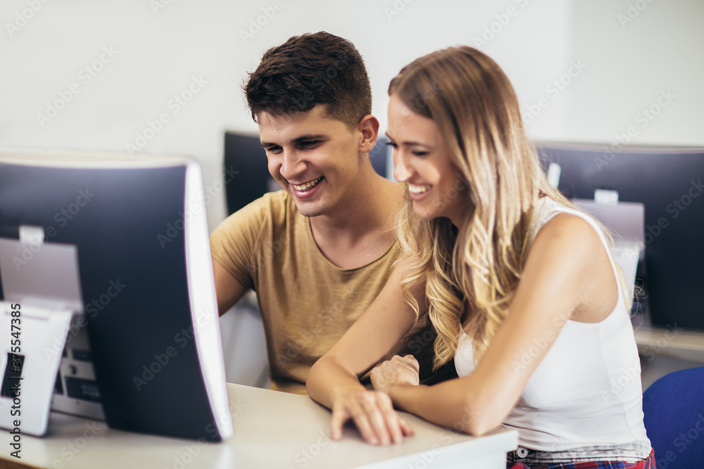 College students in a computer lab, using computers during class. College students in a computer lab, using computers during class.