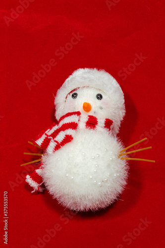 red christmas background with toy snow man.and space to add text