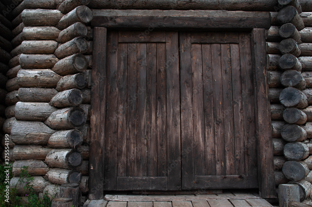 large wooden door in an old country house made of timber large wooden door in an old country house made of timber